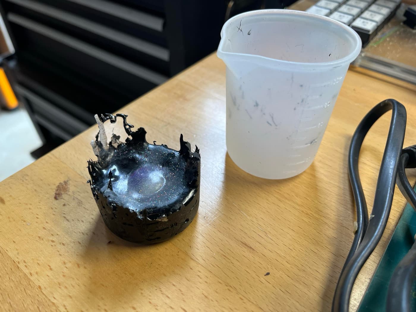 Close-up of a bumpy, multicolored plastic artifact made from melted 3D printer scraps